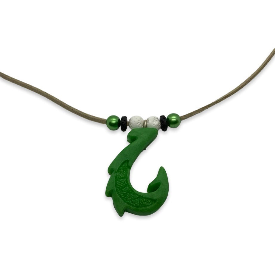 Green fish hook pendant on a necklace with beads against a white background