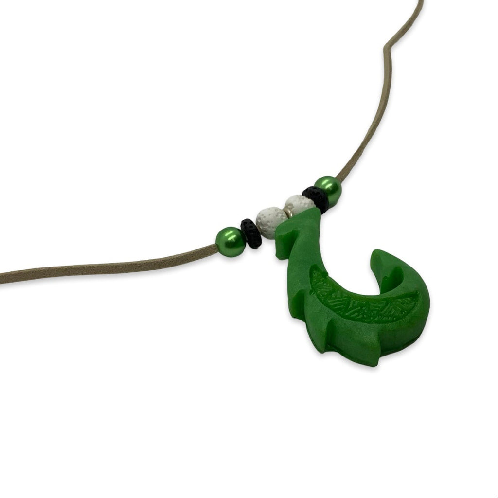 Green fishing lure on a brown string against a white background