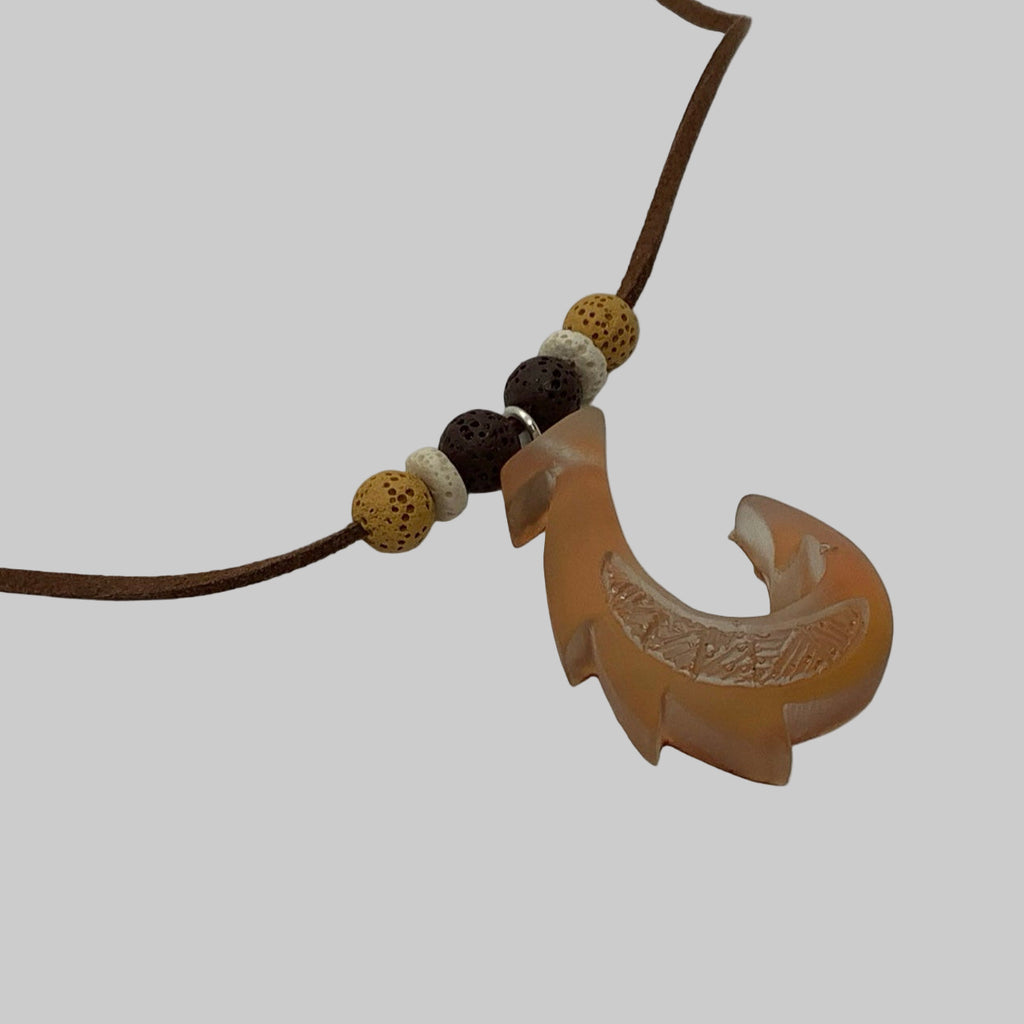 Chameleon Gold  fish hook pendant with beads on a white background