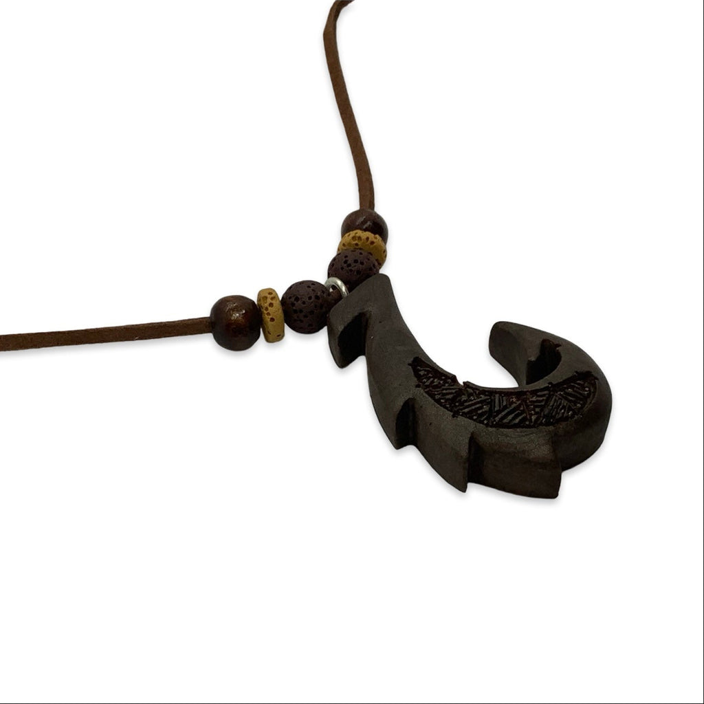 Black fish hook pendant on a brown cord with beads against a white background