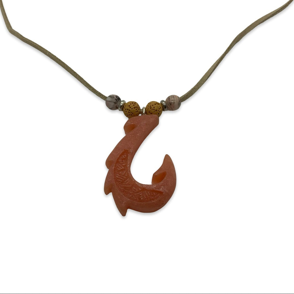 Wooden fish hook pendant on a cord against a white background
