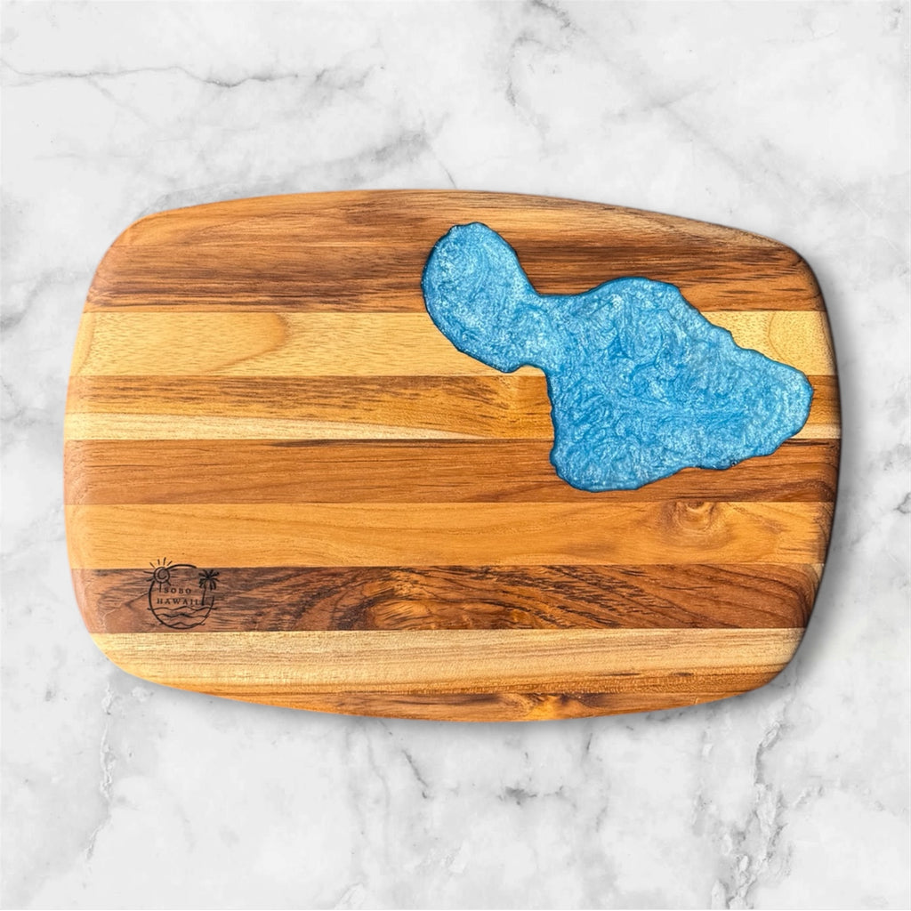 Wooden cutting board with blue resin design.