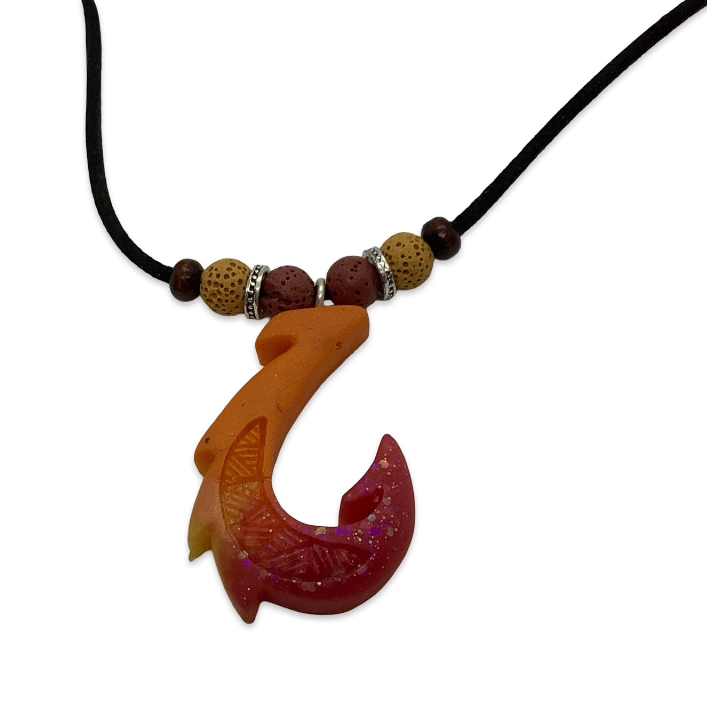 Hook-shaped pendant with beads on a black cord against a white background