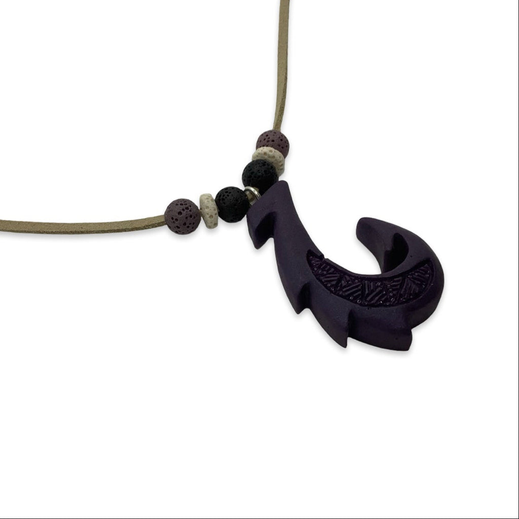 Necklace with a purple fish hook pendant on a white background
