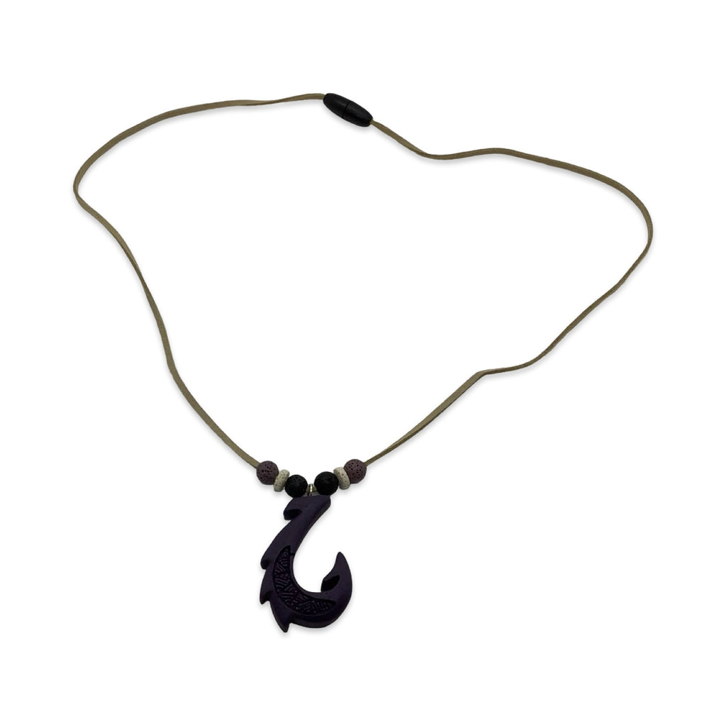 Black fish hook pendant on a cord against a white background