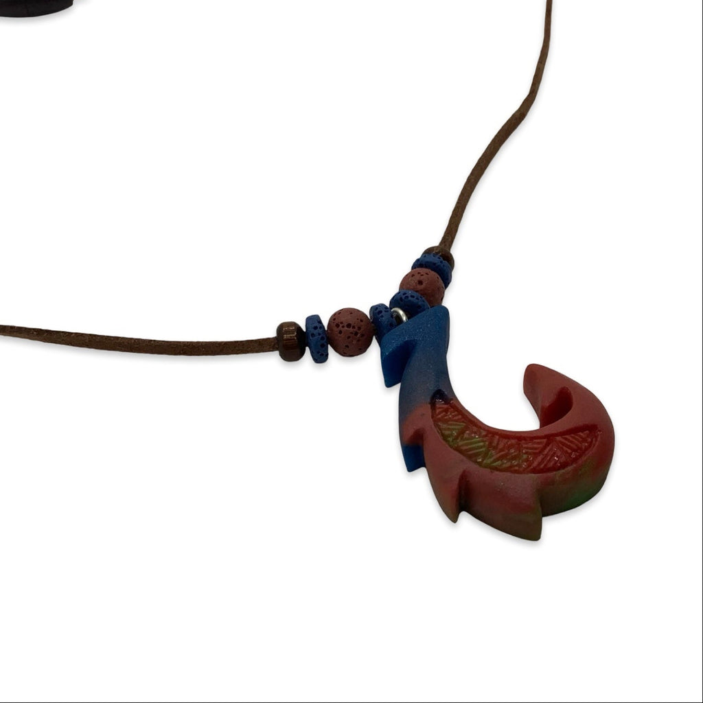 Brown leather necklace with a fish-shaped pendant on a white background