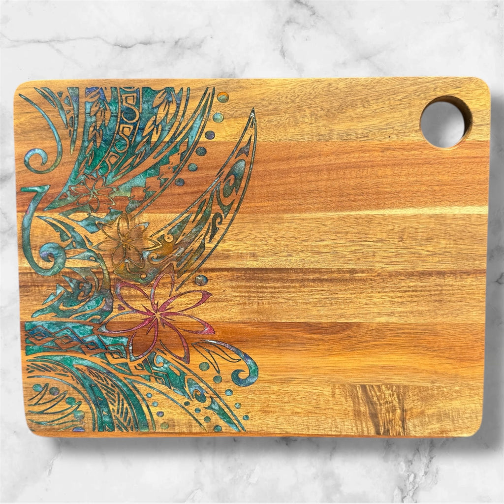 Wooden cutting board with floral and feather design on a marble background