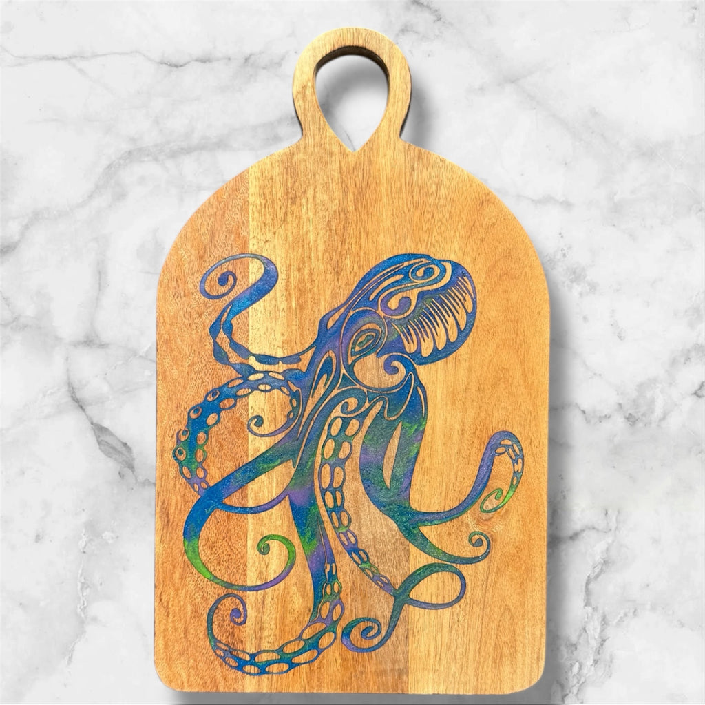 Wooden cutting board with a colorful octopus design on a marble surface