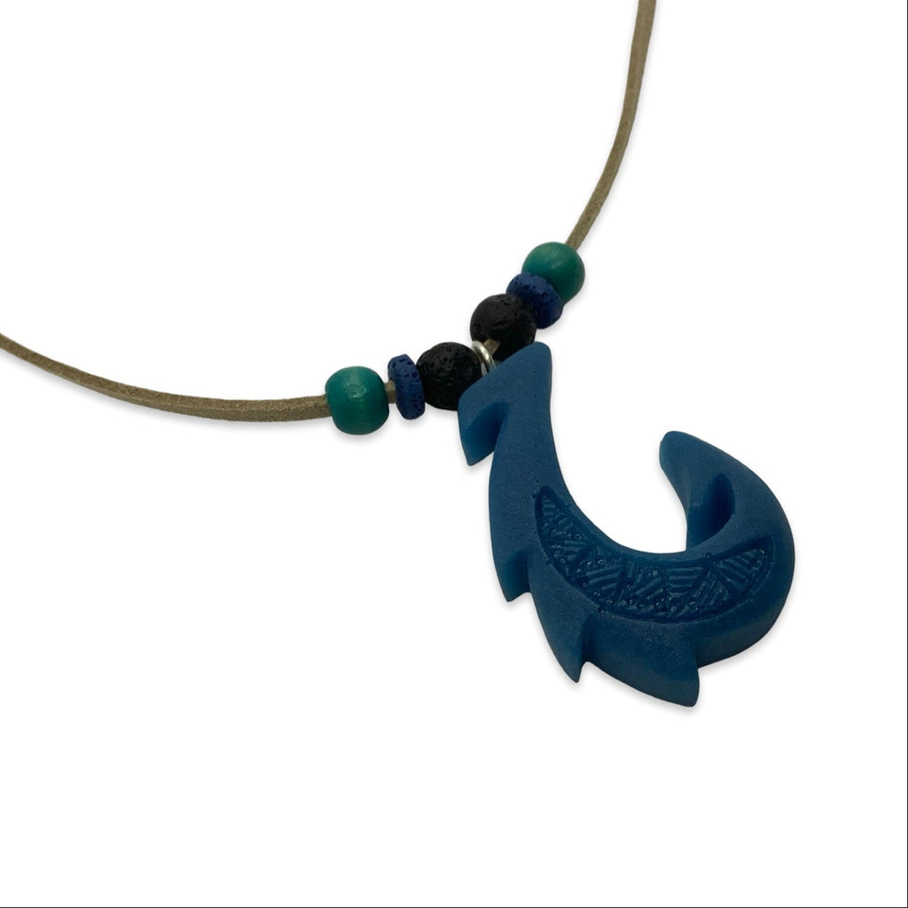 Necklace with a blue fish-shaped pendant and beads on a white background