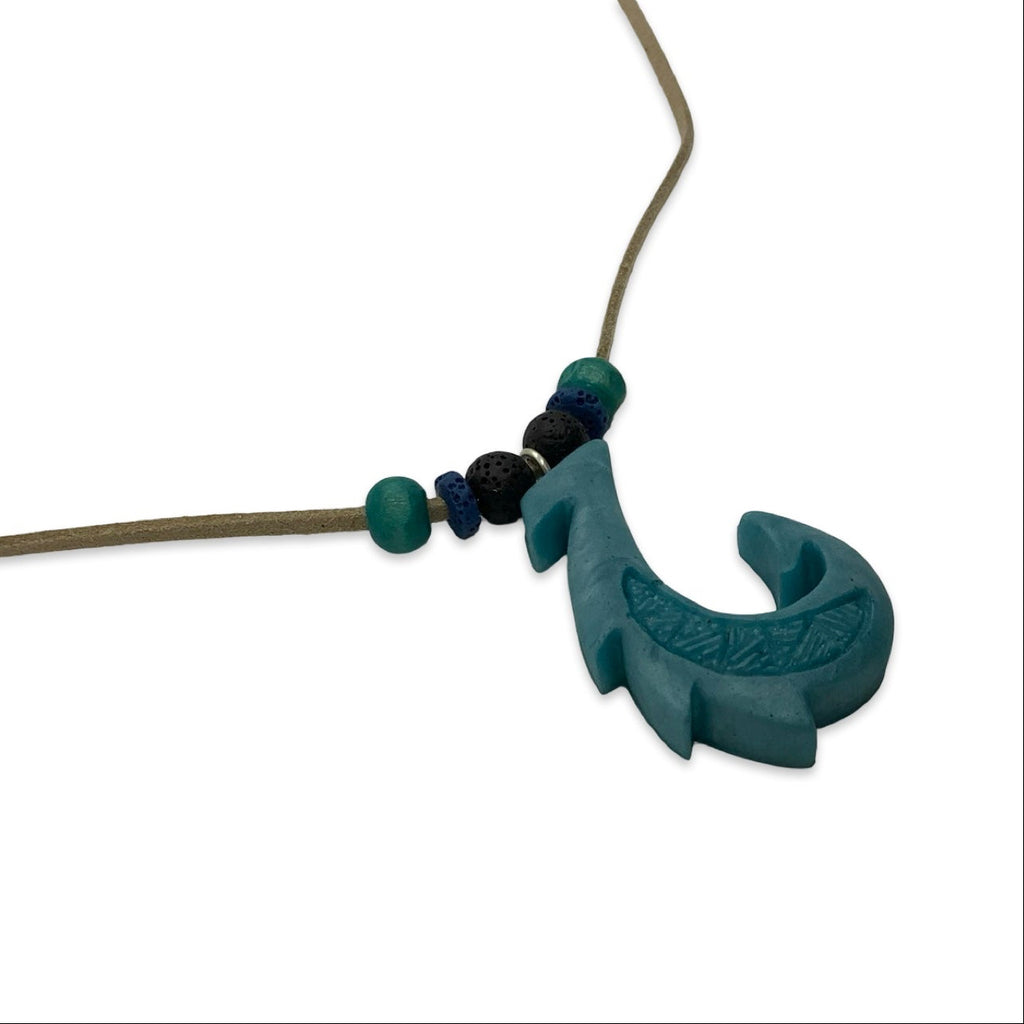 Teal necklace with a unique design on a white background