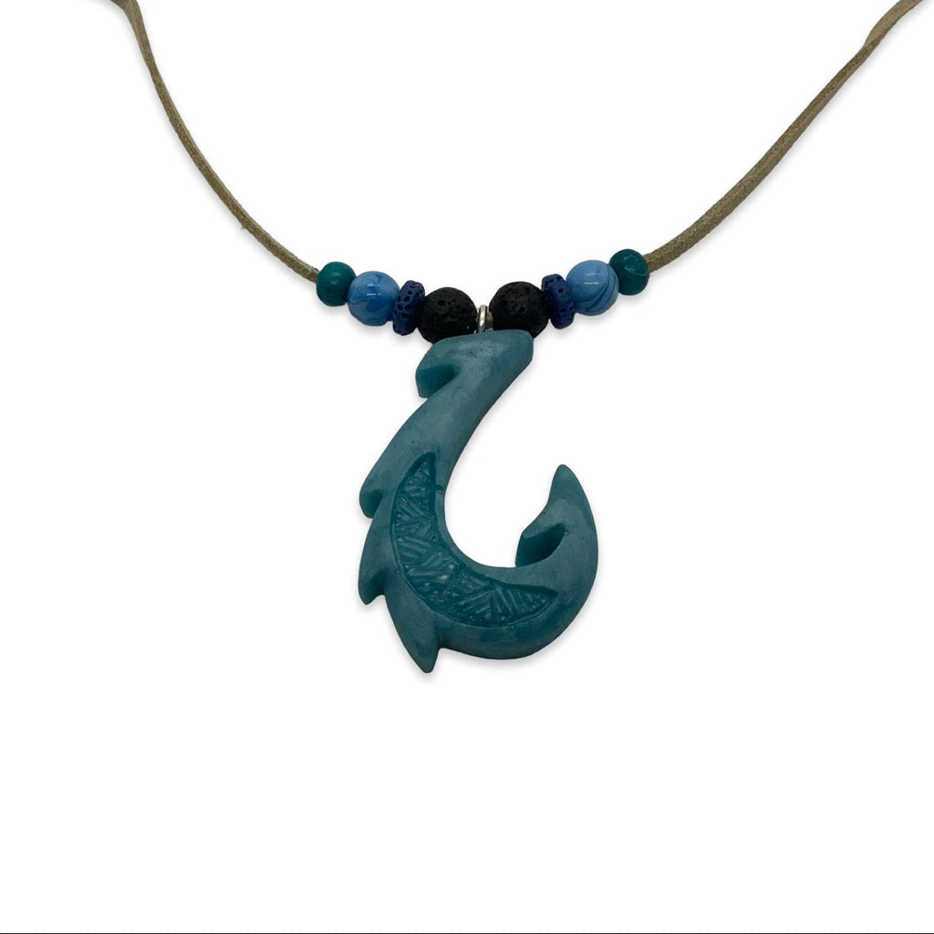 Necklace with a blue fish hook pendant and beads on a white background