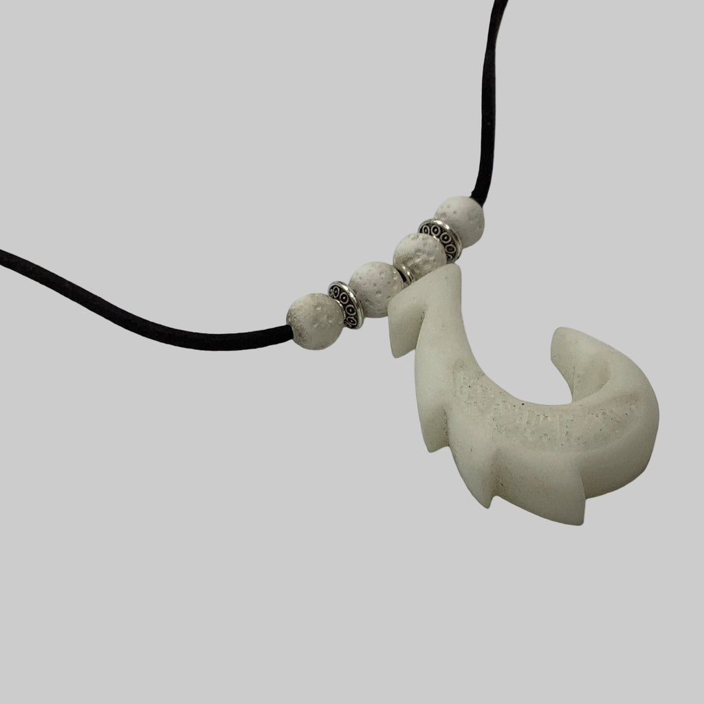 Necklace with a hook-shaped pendant on a white background