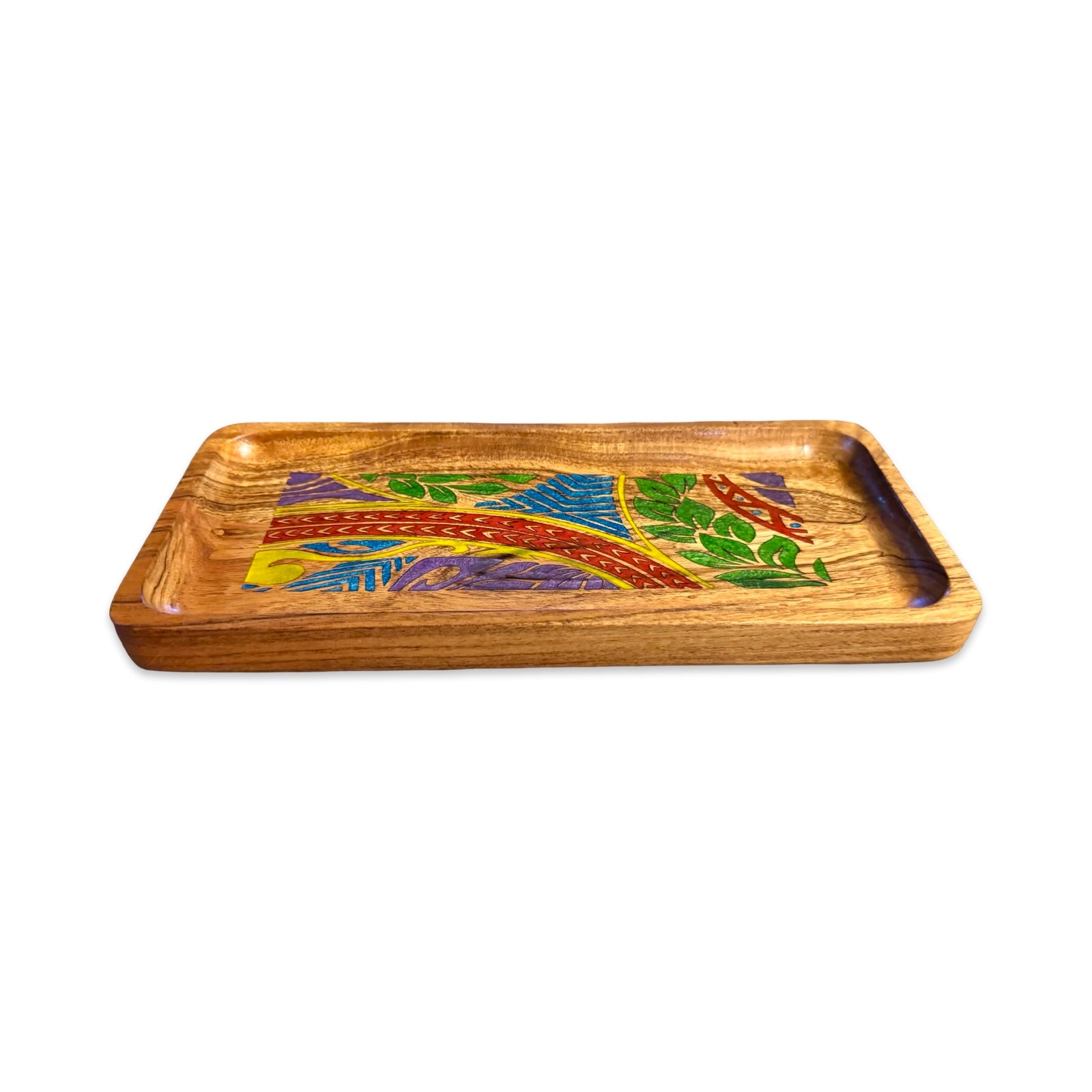 A rectangular wooden serving tray with a vibrant, multicolored inlaid landscape design featuring green trees, blue water, and a winding red path, shown on a plain white background.