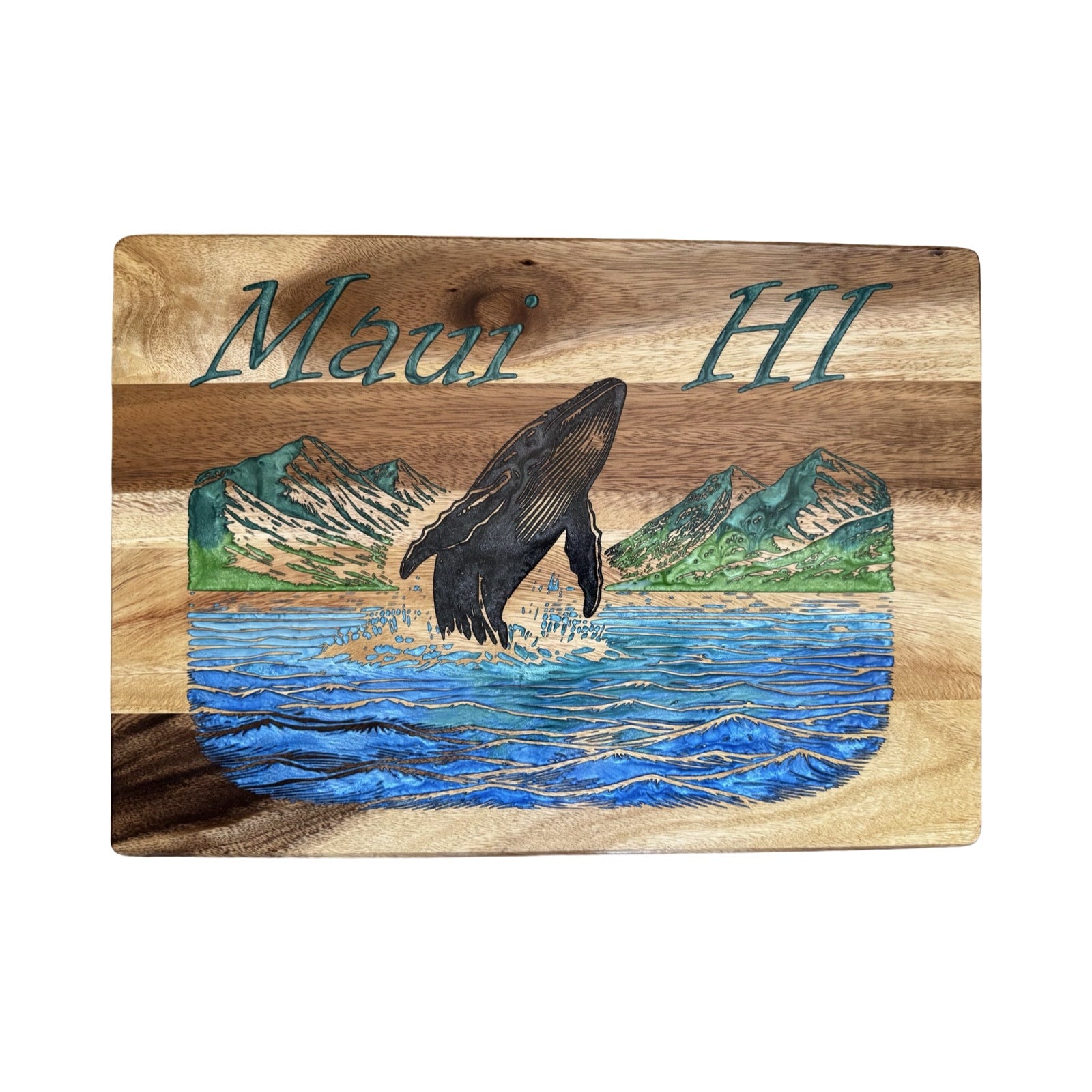 Wooden cutting board with a whale and mountains design, featuring 'Maui HI' text.