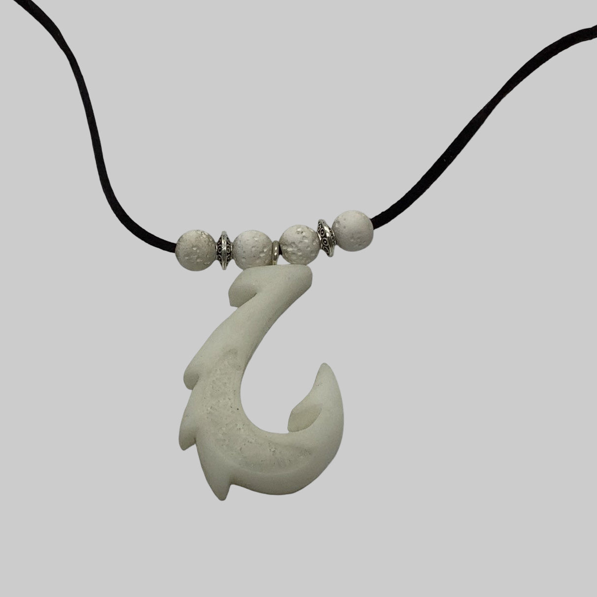 Necklace with a hook-shaped pendant on a white background
